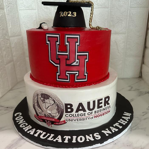 A sheet cake with a graduation cap design, personalized with the graduate's name and year.