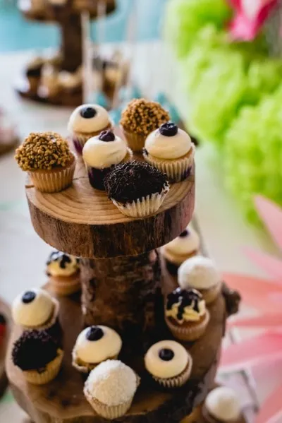 A close-up of a delicious wedding or event cake with a rich chocolate flavor, made with very sweet chocolate cupcakes as well.